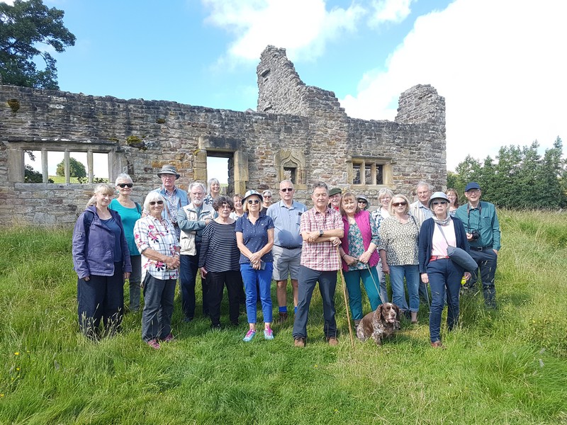 Crake Trees Group in front of a ruined building